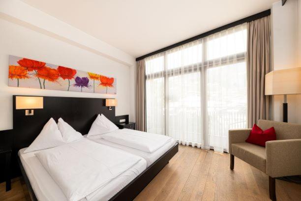 A bed or beds in a room at Hotel Heitzmann
