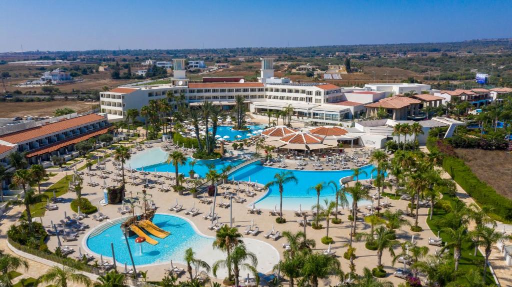 an aerial view of a resort with pools and slides at Olympic Lagoon Resort Ayia Napa in Ayia Napa