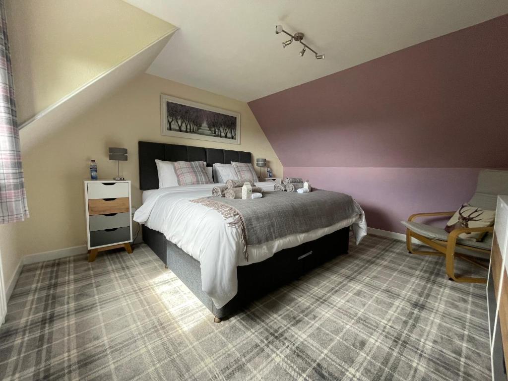 a bedroom with a large bed in a attic at Craggan in Dornoch