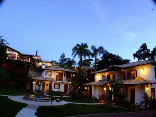 a large house with a driveway in front of it at Lis Bleu Pousada in Tiradentes