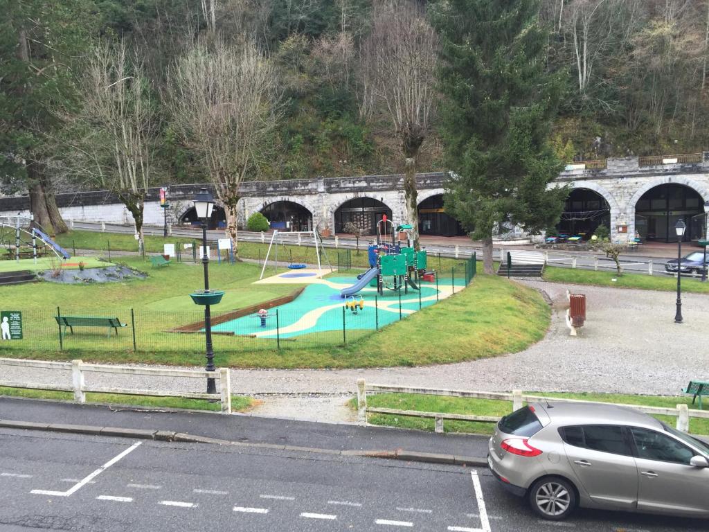 a park with a playground with a slide at appartement à la montagne in Eaux-Bonnes
