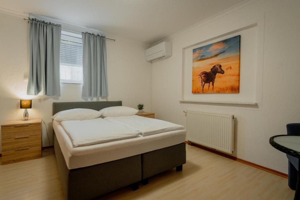 Postel nebo postele na pokoji v ubytování Park Hotel & Gästehaus Rust