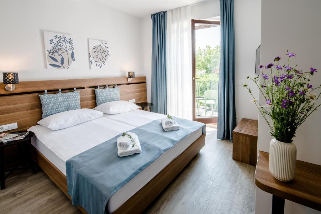 a bedroom with a bed with two towels on it at B&B Pod vrbo in Ljubljana