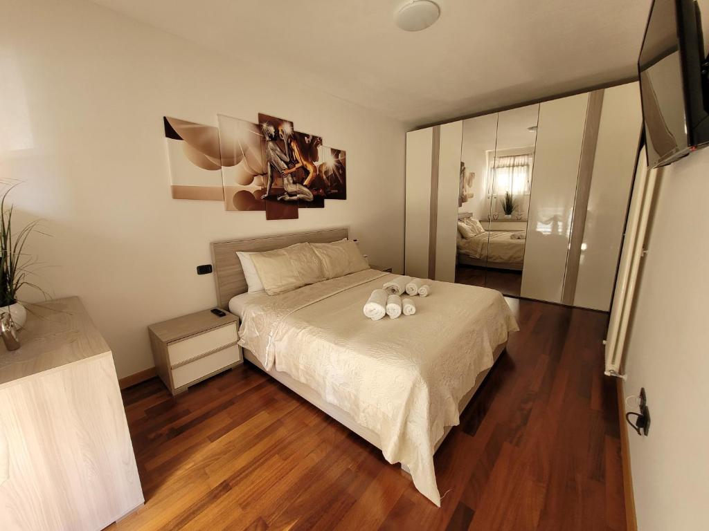 a bedroom with a bed with white pillows on it at RIVA DEL GARDA APART in Riva del Garda