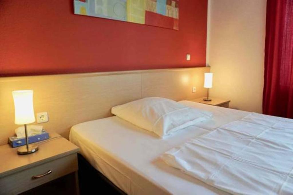 Postel nebo postele na pokoji v ubytování Hotel Aurelia