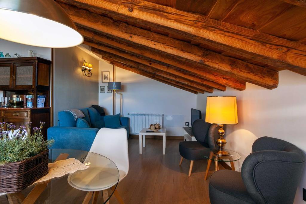 a living room with blue chairs and a table at Apartamentos Top Medieval in Sigüenza