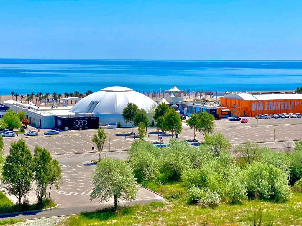 a large tent in a parking lot next to the ocean at Blue Summerland Apartments in Mamaia