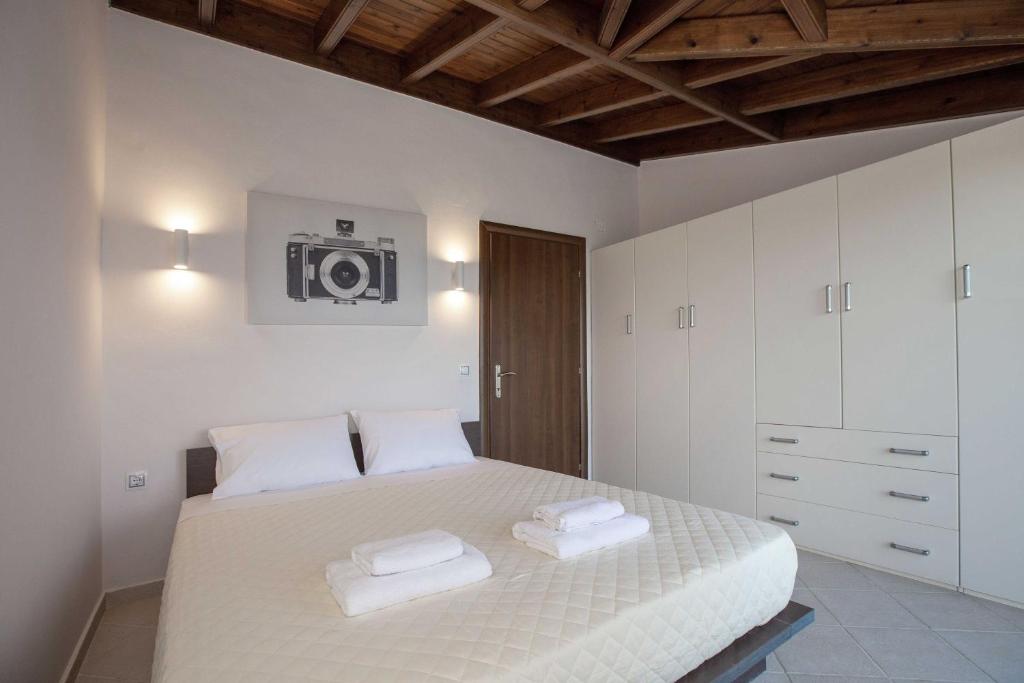 A bed or beds in a room at Spacious House with extraordinary view in Corfu