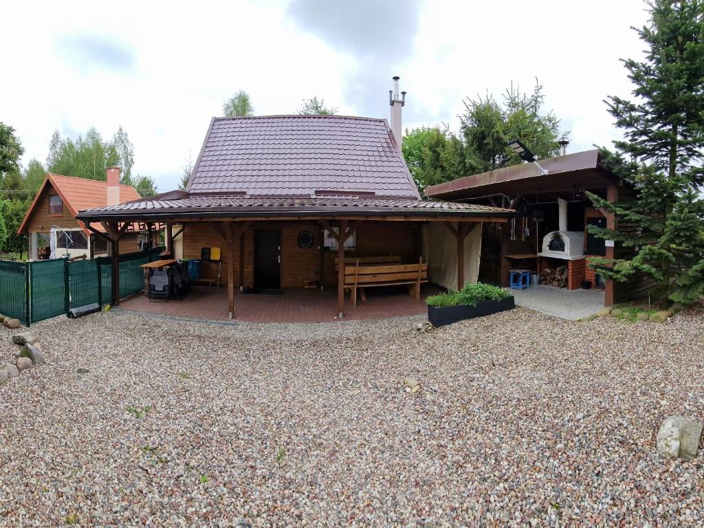 a house with a pavilion with a patio at Wilkiejmy wieś in Jeziorany