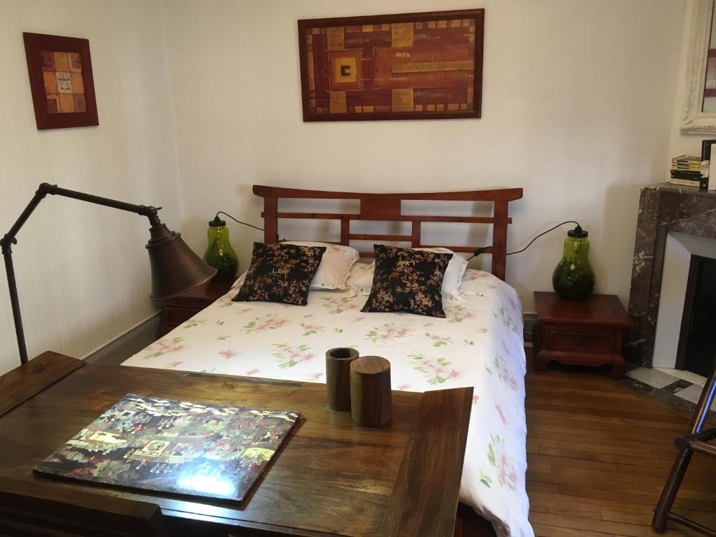 a bedroom with a bed and a wooden table with a table at Le Campus Victoria I - Train Station & Isabey St - 70m2 in Nancy