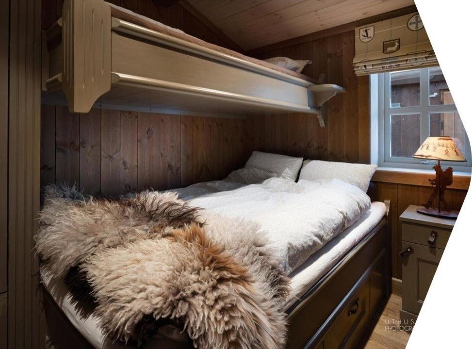 a bedroom with a bed with a furry blanket on it at Beautiful cabin close to activities in Trysil, Trysilfjellet, with Sauna, 4 Bedrooms, 2 bathrooms and Wifi in Trysil