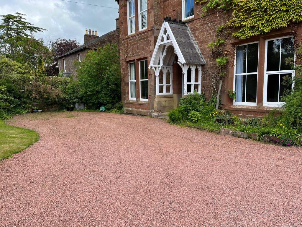 a driveway in front of a brick house at Edenwood, The Green, Wetheral in Wetheral