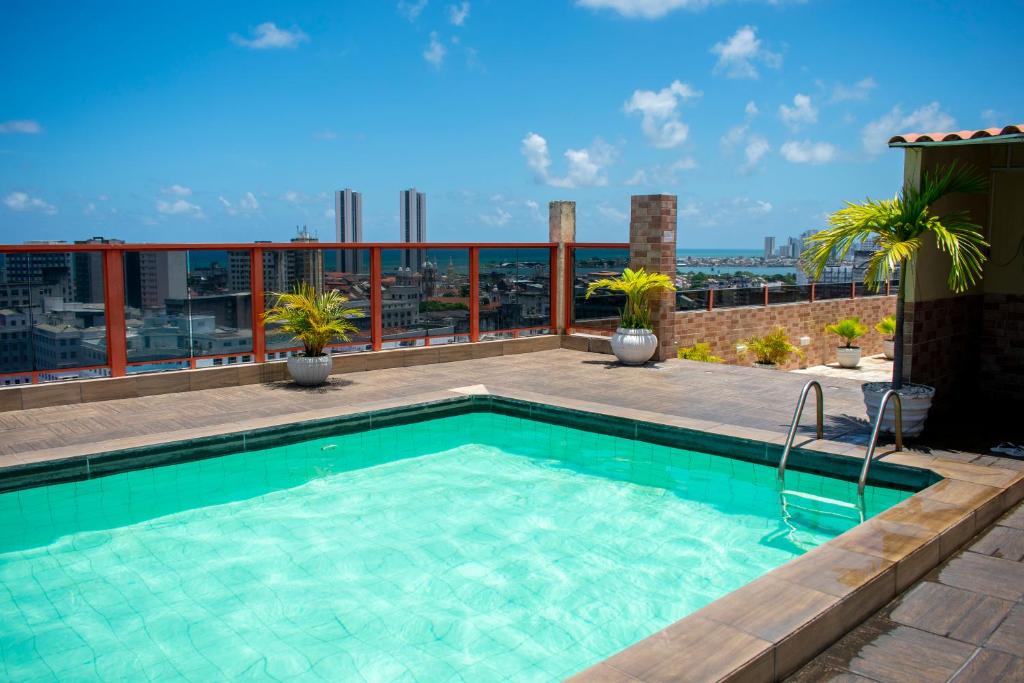 a swimming pool on the roof of a building at Rede Andrade Plaza Recife in Recife