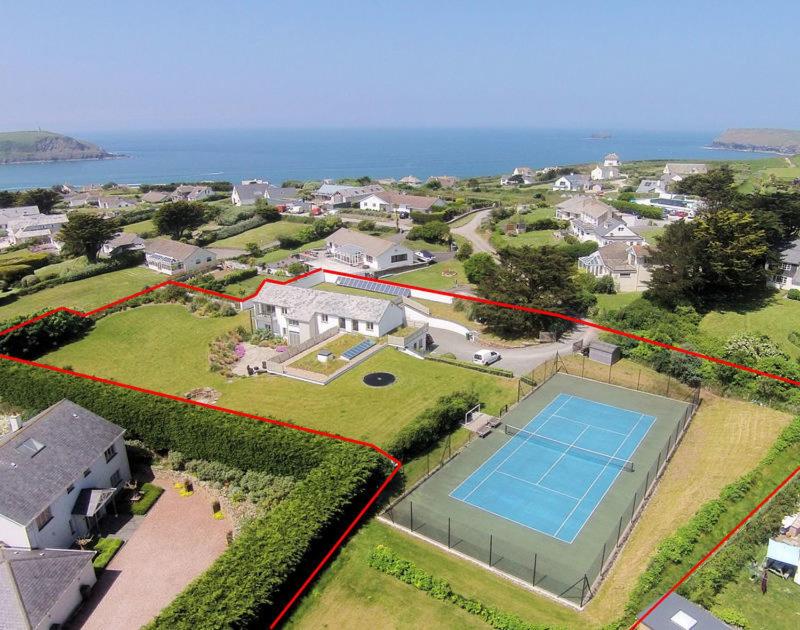 an aerial view of a house with a tennis court at Downalong in Polzeath