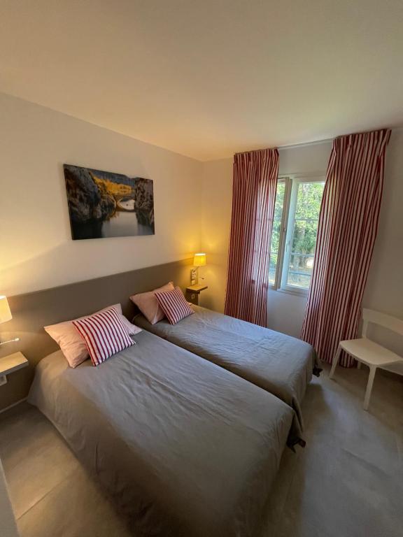 a bedroom with two beds and a window at CASA RAMA ST Tropez in Saint-Tropez