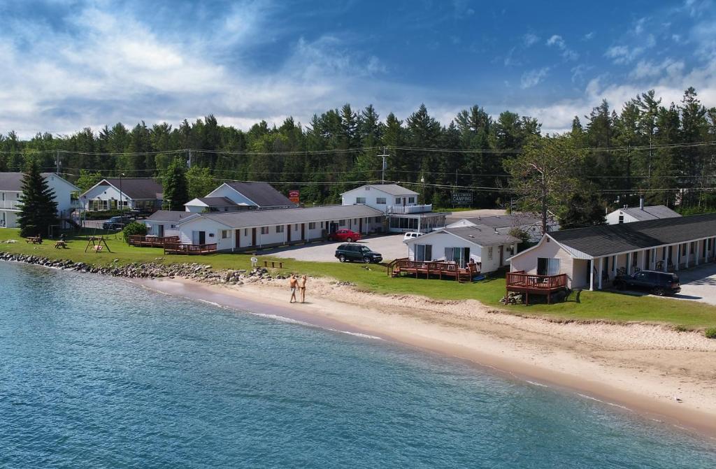 an aerial view of a beach with houses and the water at Bells Melody Motel in Mackinaw City