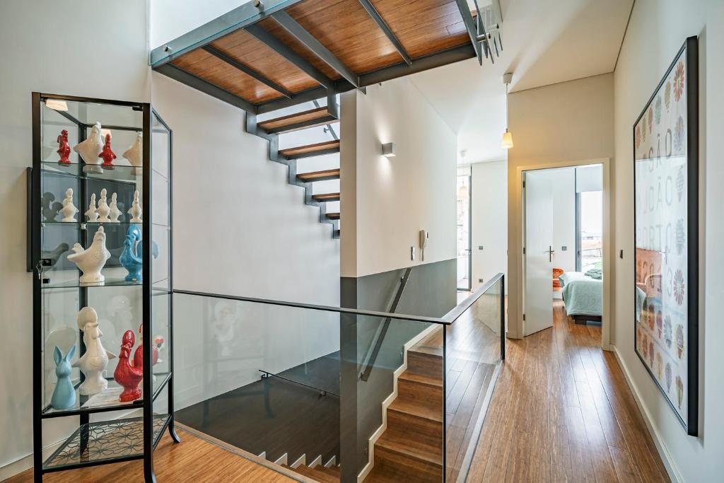 a glass staircase leads to the second floor of a house at Art City Villa in Porto
