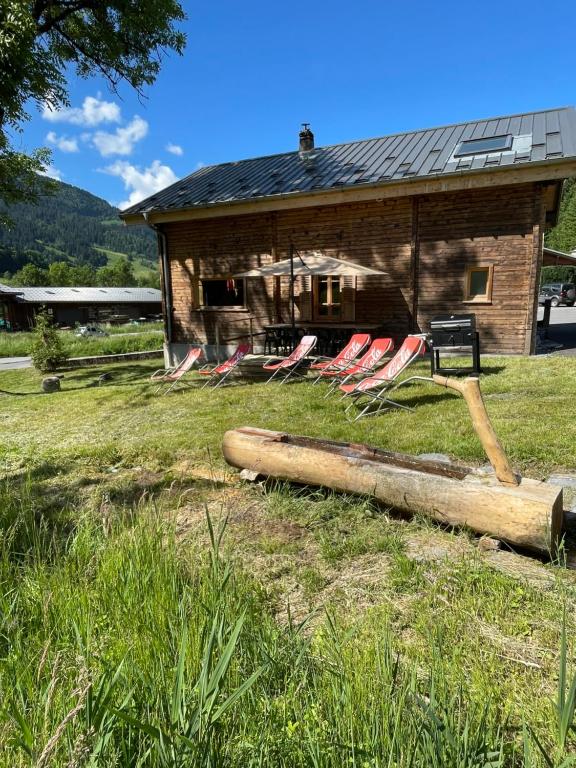a group of chairs sitting in front of a house at Chalet Tire-corde in Praz-sur-Arly