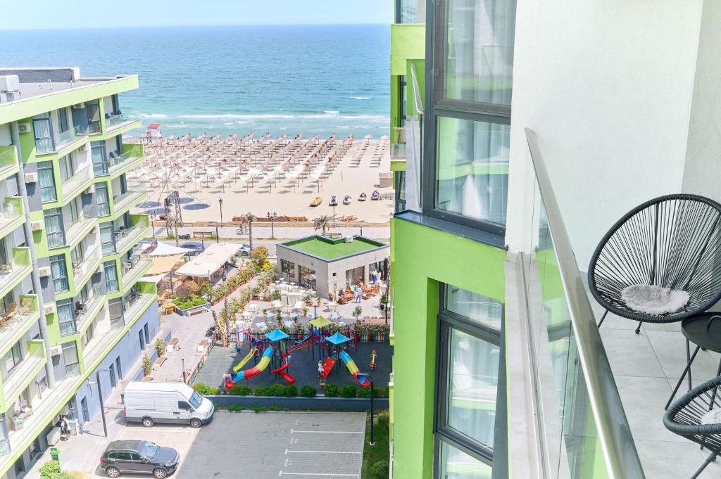 a view of the beach from the balcony of a building at Rainbow sea view apartment Spa n Pool resort - parking in Mamaia