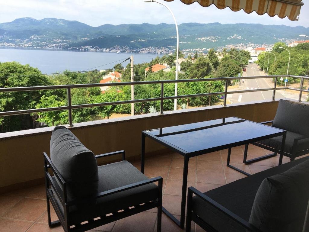 a balcony with a table and chairs and a view at Swimming Apartment in Rijeka