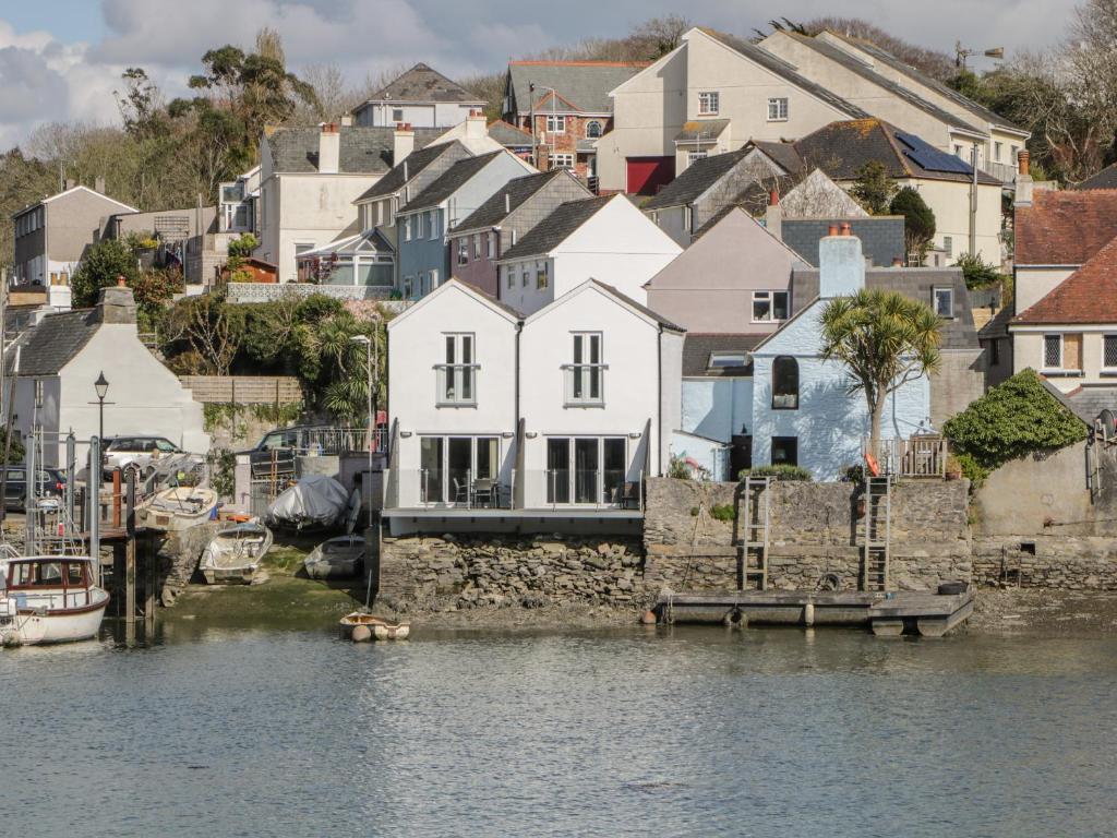 a group of houses next to a body of water at Oak Cottage in Plymouth
