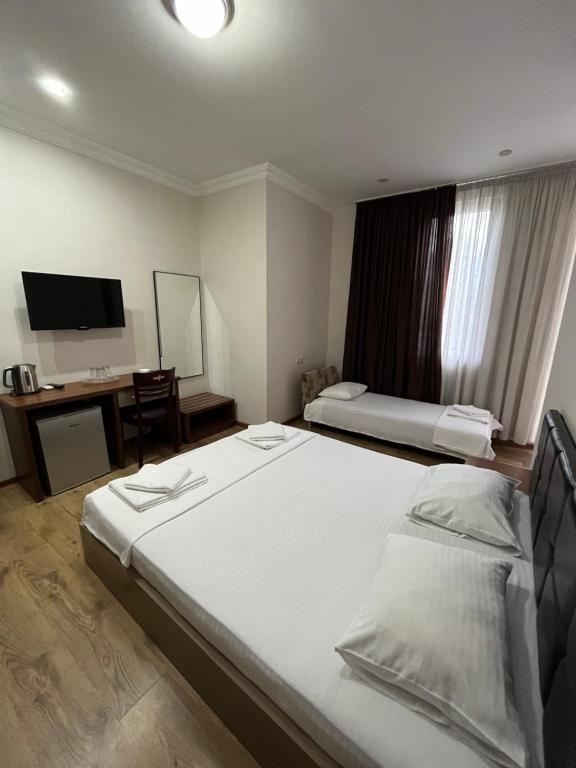 Postel nebo postele na pokoji v ubytování Ventura Hotel