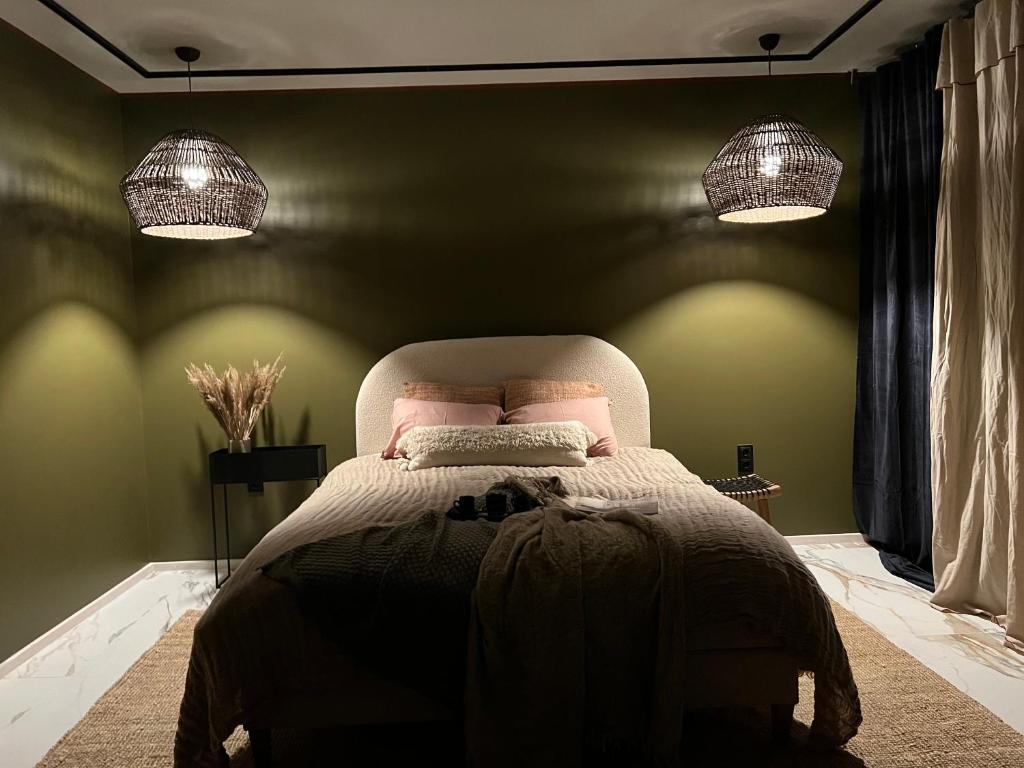 a bedroom with a large bed with two lights at Cozy beach house Jurmala II in Jūrmala