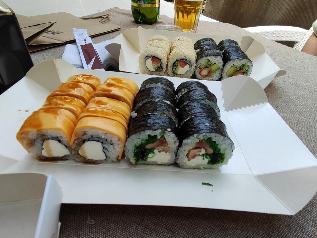 a plate of sushi and rolls on a table at Гостевая комната in Chernivtsi