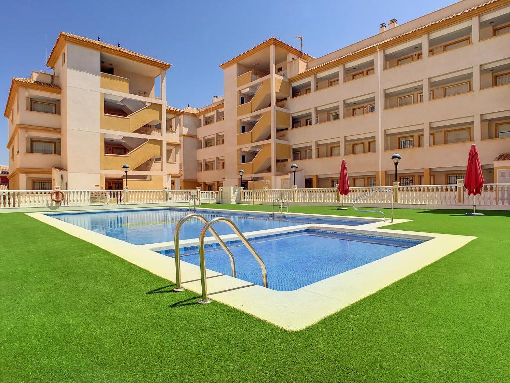 a swimming pool in front of a building at Ribera Beach 2 - 1106 in Mar de Cristal