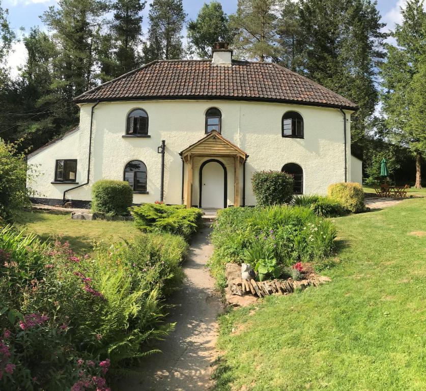 a white house with a pathway leading to it at Barn Owl Cottage in Minehead