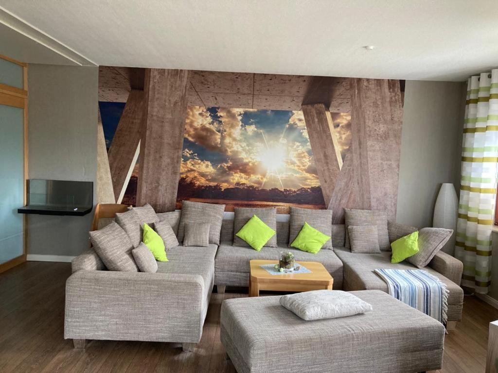 a living room with a couch and a painting on the wall at Adlerhorst in Zislow