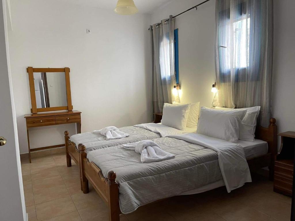 a bedroom with two beds with towels on them at LUNAR MELODY in Karpathos