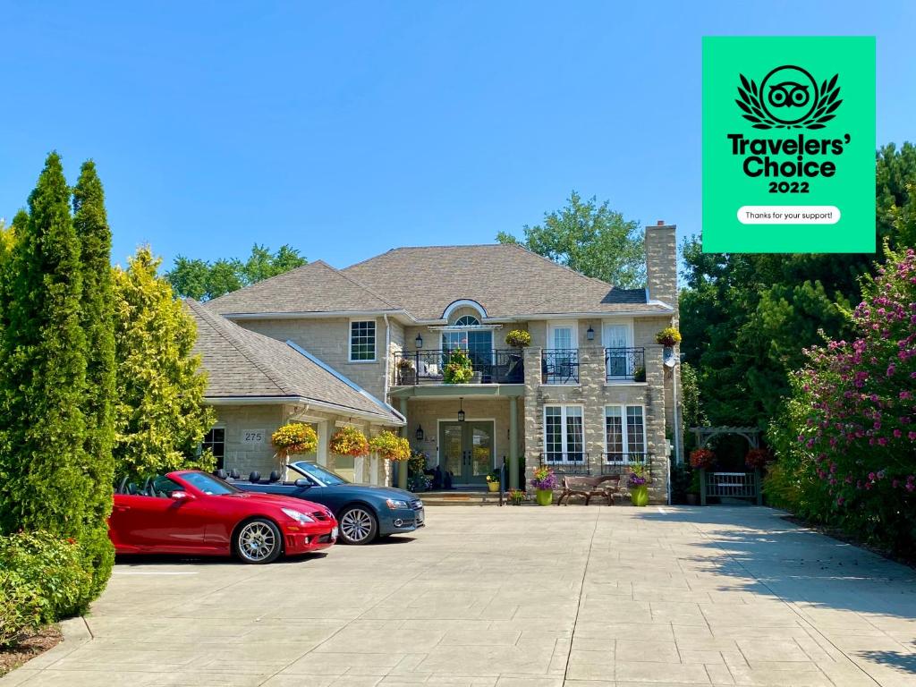 a house with two cars parked in a driveway at Explorer House Bed & Breakfast in Niagara-on-the-Lake