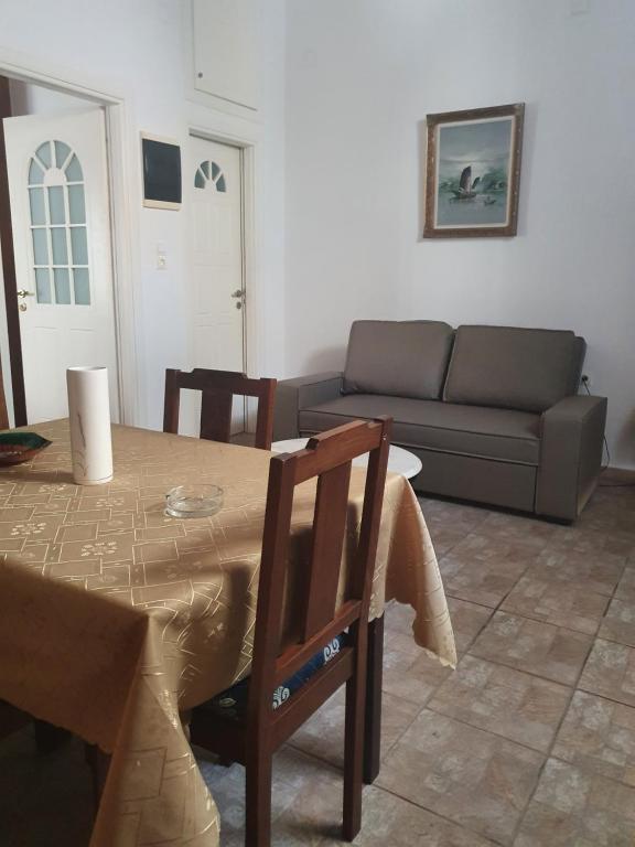 a living room with a table and a couch at Callisto house 5 in Ermoupoli