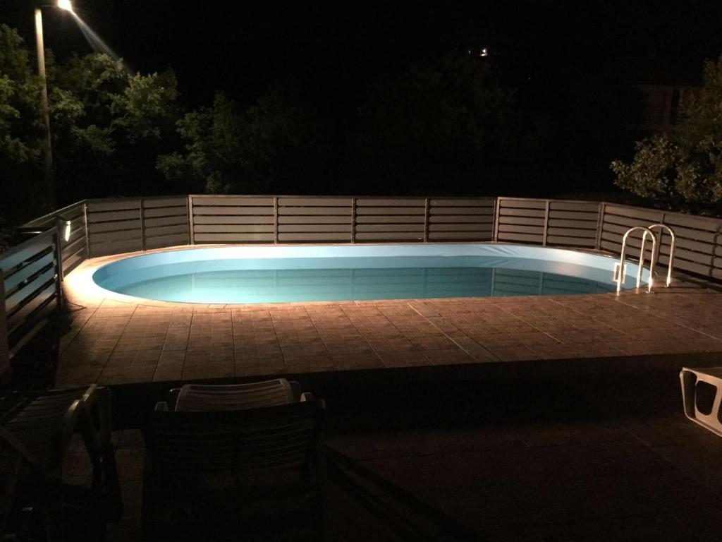 a swimming pool in a backyard at night at Studio Apartments MT in Šmrika