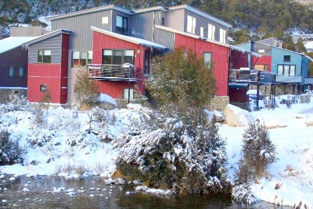 a group of houses with snow on the ground at Angala 1 Lovely Woodridge 2-Bedroom Apartment in Thredbo