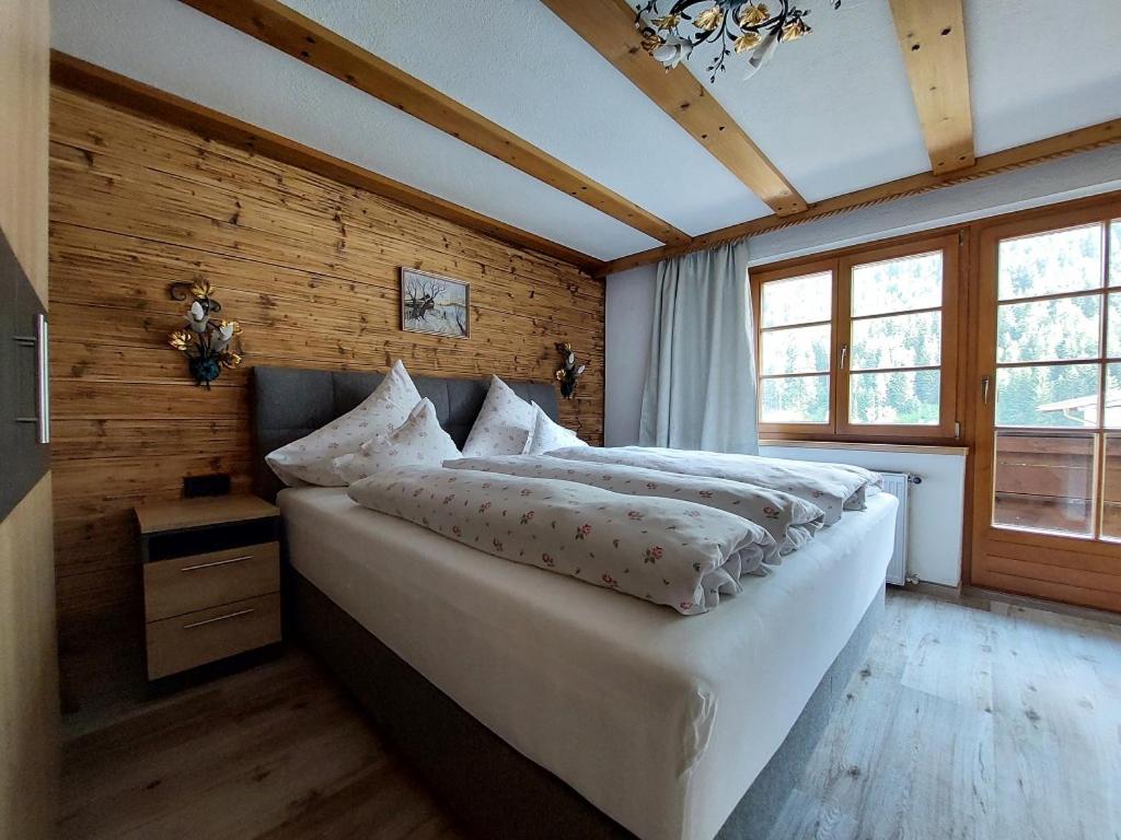 Gästehaus Rita في سانكت أنتون ام ارلبرغ: غرفة نوم مع سرير أبيض كبير في غرفة
