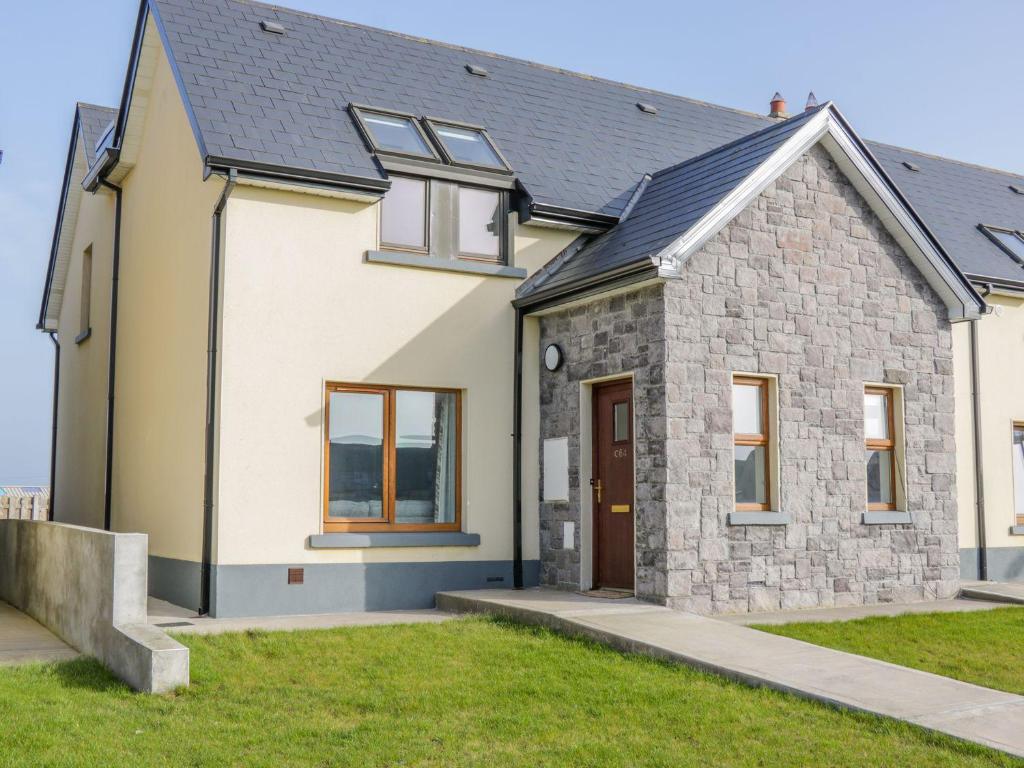 a detached house with a grey roof at C64 Cahermore Holiday Village in Enniscrone