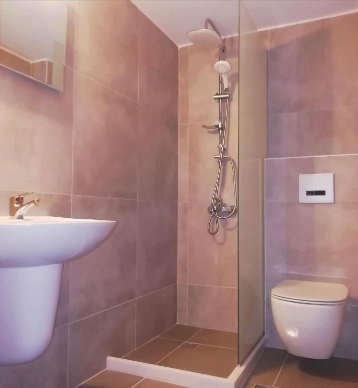 a bathroom with a toilet and a sink at Hotel Thisvi in Stalís