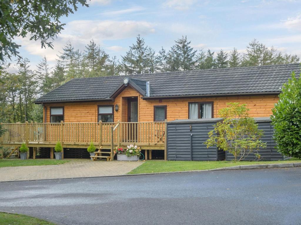 a home with a wooden fence and a house at Oaks One in Morpeth