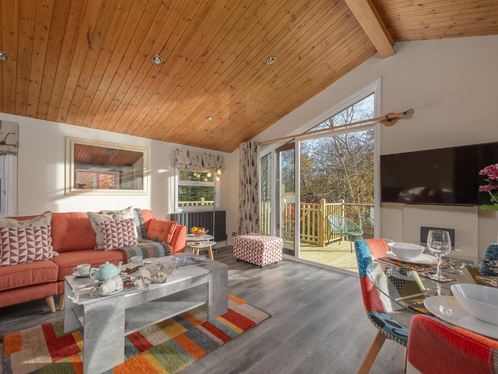 a living room with a couch and a table at Oaks One in Morpeth