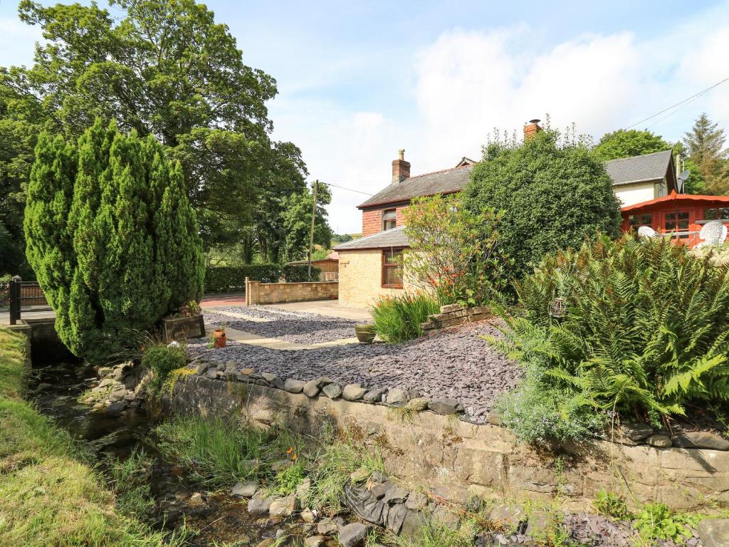 a garden in front of a house at Brook Cottage in Llanidloes