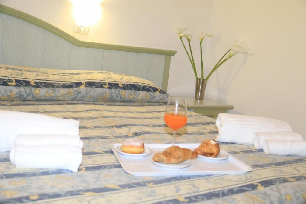 Postel nebo postele na pokoji v ubytování Hotel Ginevra e Residence