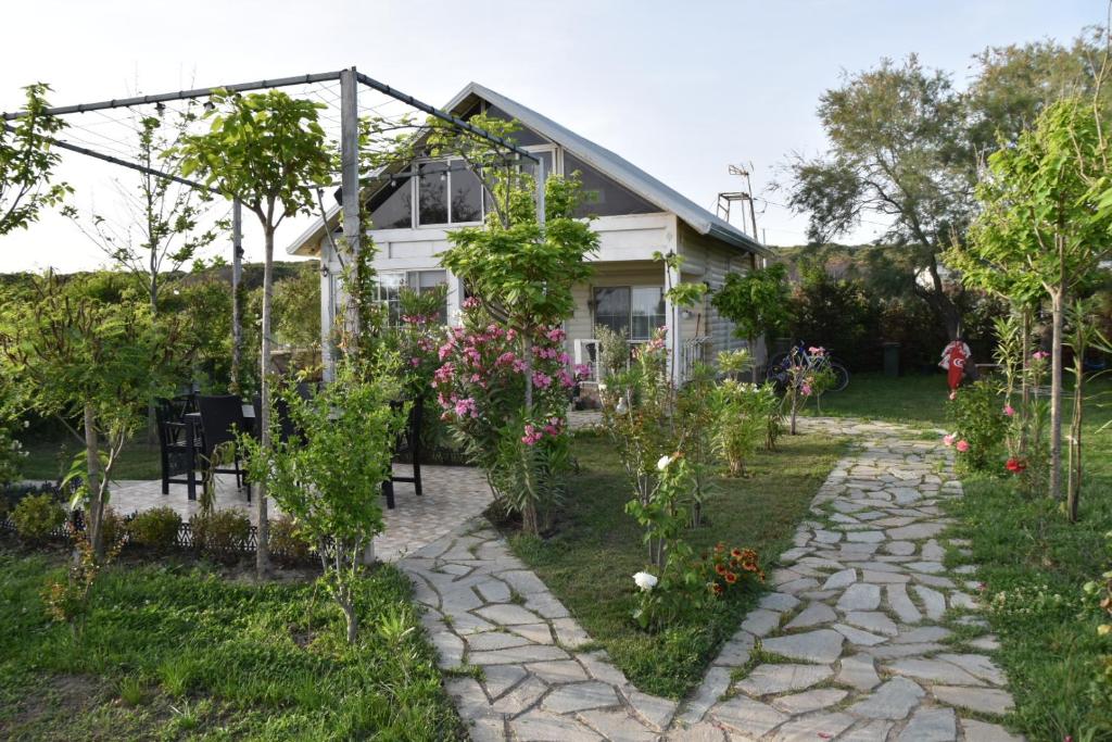 a garden in front of a house at Beachfront, Tirana Guest House in Velipojë