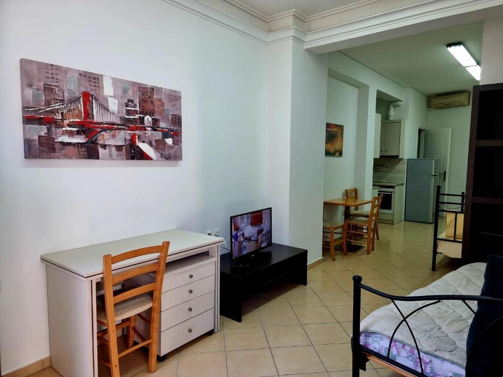 a living room with a white dresser and a bedroom at tripoli central accommodation in Tripolis
