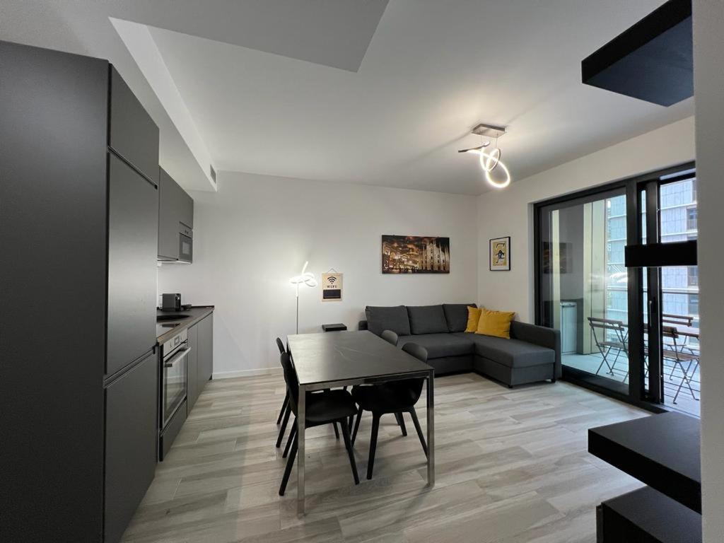 a living room with a table and a couch at Kibilù - Cascina Merlata Rho Fiera Ospedale Galeazzi in Pero
