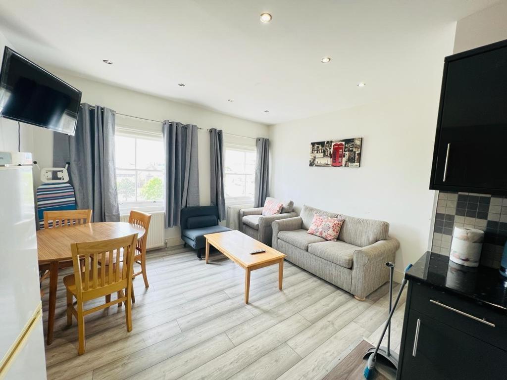 a living room with a couch and a table at Entire New Flat With View to River Yare, H7 in Great Yarmouth