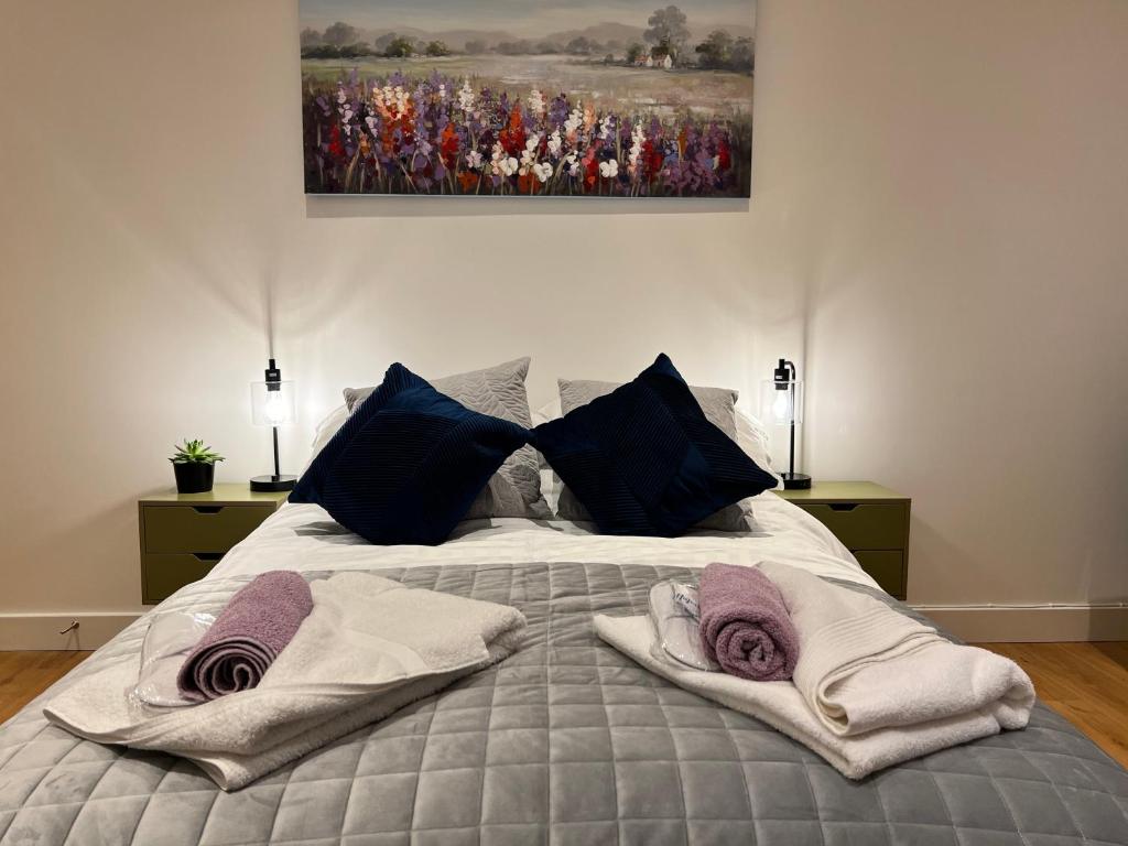 a bedroom with a bed with towels on it at Lavender Retreat in Wrexham