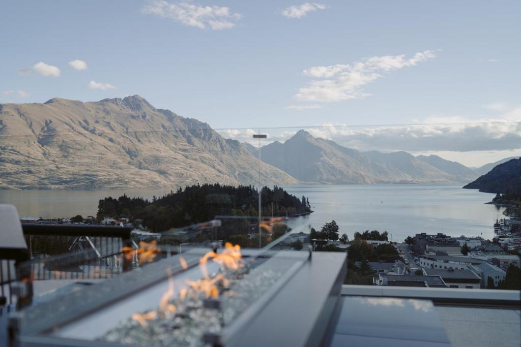 a view of a lake and mountains from a balcony at The Carlin Boutique Hotel in Queenstown