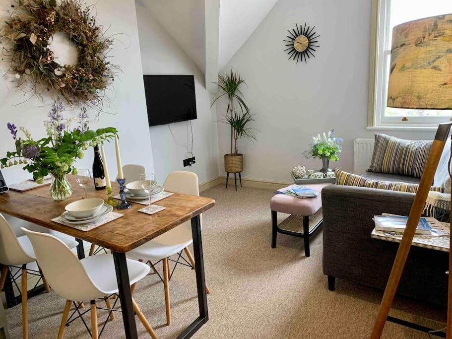 a living room with a table and a couch at The Nest, central Ludlow one bed apartment in Ludlow